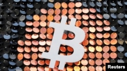 FILE - The logo of the Bitcoin digital currency is seen in a shop in Marseille, France, Feb. 7, 2021.