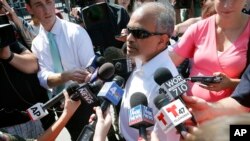 Sranivasa Rao, center, from Floral Park, Queens, N.Y., updates reporters about his flight aboard an Emirates airliner after an emergency was declared when the plane landed at JFK Airport with ill passengers on a flight from Dubai, Sept. 5, 2018, in New York. On Sept. 6, passengers and crew on two flights arriving in Philadelphia from Europe were screened by medical teams after 12 people aboard became ill with flu-like symptoms.