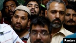 Asian workers gather as they speak to Reuters' journalists at their accommodation in Qadisiya labor camp, Saudi Arabia, Aug. 17, 2016.