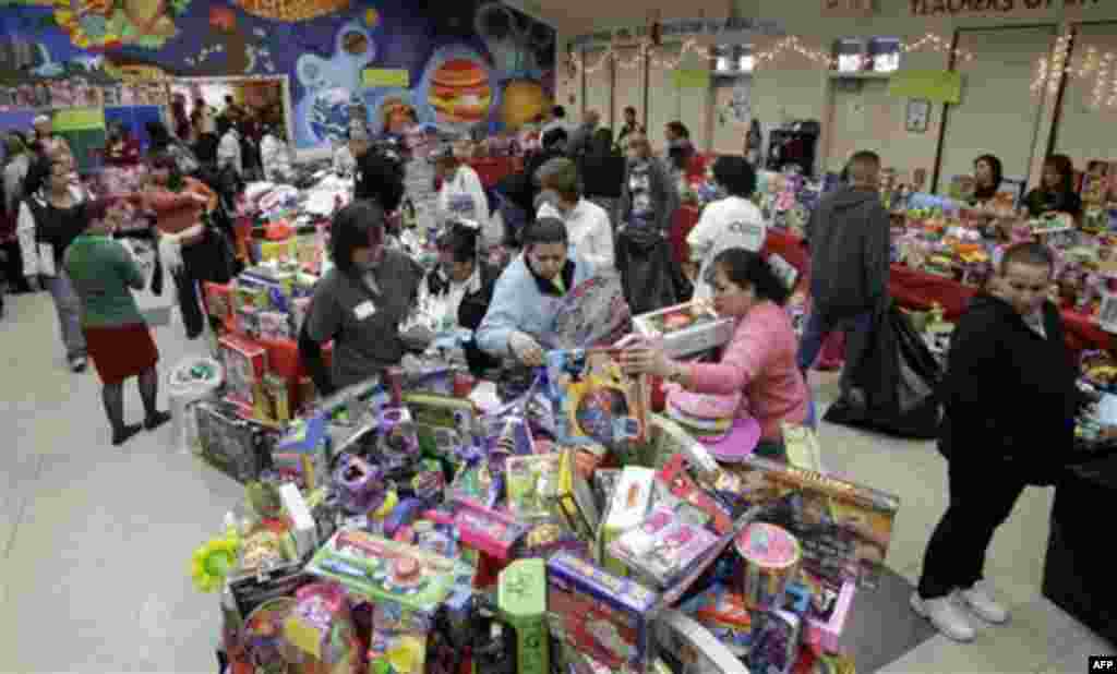 Families sift through a pile of toys at Sacred Heart Community Service in San Jose, Calif., Wednesday, Dec. 22, 2010. The center is providing some 20, 0000 toys to 5,000 low-income families for the holidays. (AP Photo/Marcio Jose Sanchez)