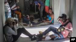 Journalists sit wounded after being shot by armed gangs at the General Hospital in Port-au-Prince, Haiti, Dec. 24, 2024.