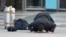 FILE - An Afghan, whose asylum application was rejected, kisses the ground after arriving from Germany, in Kabul airport, Afghanistan.