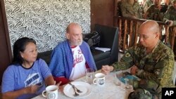 Mayjen Corleto Vinluan (kanan), bersama warga Inggris yang diselamatkan, Allan Hyrons (tengah) dan istrinya (warga Filipina), Wilma di kamp militer Filipina, Jolo, provinsi Sulu, Filipina, 25 November 2019. (Foto: Angkatan Bersenjata Filipina, Satuan Tugas Gabungan Sulu via AP) 