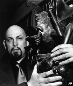 FILE - The founder of the Church of Satan, Anton LaVey, is seen at home in San Francisco, 1983.