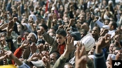 Anti-government protesters react in Tahrir Square, Cairo, Egypt, February 4, 2011