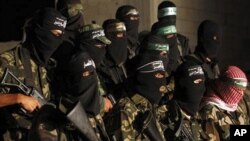 Masked Palestinian Hamas militants hold a press conference in Gaza City, 2 Sept. 2010.