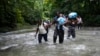 FILE - Haitian migrants wade through a river as they cross the Darien Gap, from Colombia into Panama, hoping to reach the U.S., Oct. 15, 2022. 