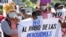A man holds a sign with a message that reads in Spanish; "Don't steal our pensions," during a protest against the country adopting Bitcoin as legal tender, along the Pan-American Highway, in San Vicente, El Salvador, September 7, 2021. 
