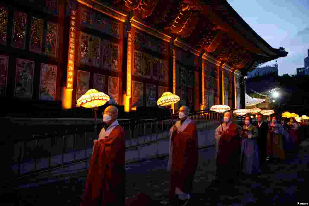 Buddhist monks and believers attend a lantern parade in celebration of the upcoming birthday of Buddha at a temple in Seoul, South Korea.