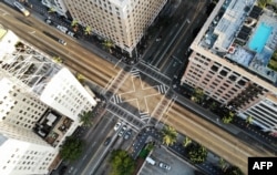 LOS ANGELES, CALIFORNIA - MARCH 25: An aerial view shows the intersection of Hollywood and Vine, shortly before sunset, with lighter than normal traffic as the coronavirus pandemic continues on March 25, 2020 in Los Angeles, California.