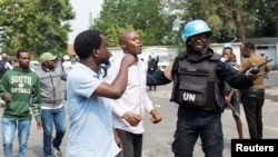 FILE: A United Nations Organization Stabilization Mission in the Democratic Republic of the Congo (MONUSCO) peacekeeper attempts to stop protesters in Goma in the North Kivu province of the Democratic Republic of Congo 7.25.2022