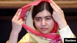 Nobel Peace Prize laureate Malala Yousafzai adjusts her scarf as she speaks during an interview with Reuters at a hotel in Islamabad, Pakistan, March 30, 2018. 