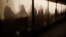 Migrants are silhouetted as they warm themselves inside a waiting tent to get an appointment at the central registration center for refugees and asylum seekers LaGeSo (Landesamt fuer Gesundheit und Soziales - State Office for Health and Social Affairs) in Berlin, Jan. 6, 2016. 
