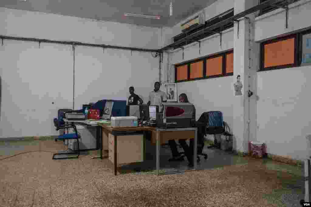 Layout designers are seen at the National Printing Press, in Bissau, Guinea-Bissau, Dec. 19, 2017. (R. Shyrock/VOA)