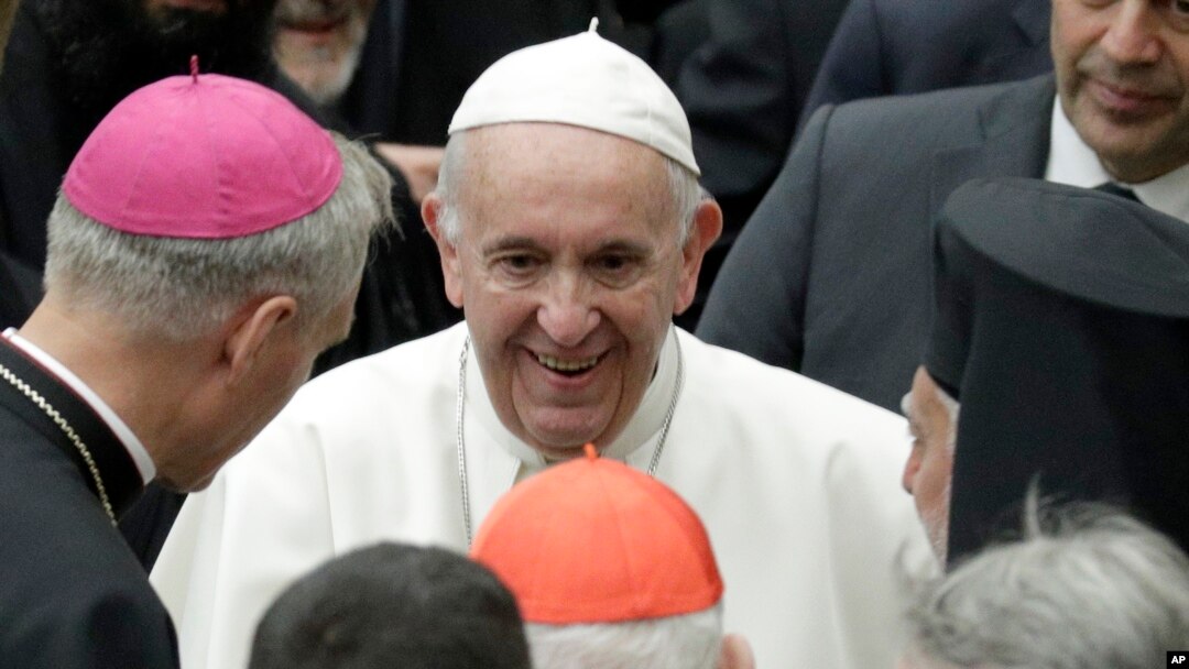 Pope Francis talks to prelates during an audience with participants of a pilgrimage of the Italian-Albanian diocese of Lungro, in the Pope Paul VI hall at the Vatican, May 25, 2019.