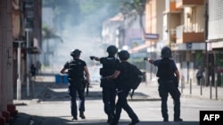 French police forces take part in an operation to remove a makeshift roadblock set up by pro-independence supporters in the Vallee du Tir district in Noumea on the French Pacific territory of New Caledonia on June 24, 2024.