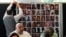Relatives of the deceased and people directly affected by the Grenfell Tower fire, sit in front of a photo montage of the those who died, as they react to the final report into the fire being released in London, Sept. 4, 2024. 