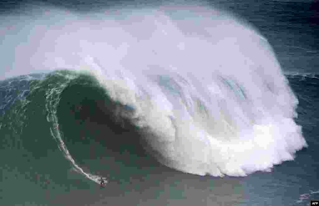 Spanish surfer Axier Muniain rides a wave during the big waves Nazare Tow Surfing Challenge in Nazare, Portugal.