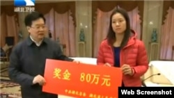 Chinese tennis star Li Na accepts a check from Hubei Communist Party chief Li Hongzhong Tuesday, January 28, 2014 following her weekend championship win at the 2014 Australian Open.