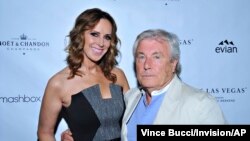 FILE - Alison Miller, Group Publisher, Los Angeles Confidential and British photographer Terry O'Neill attend the Los Angeles Confidential Magazine and SLS Las Vegas' "Celebrate the Oscars with Jared Leto" reception, Los Angeles, Feb. 28, 2014. 