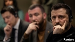 Ukrainian President Volodymyr Zelenskiy listens during a meeting with members of the media on the outskirts of London, March 2, 2025.