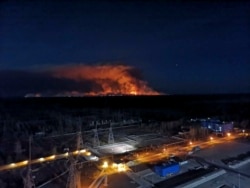In this photo taken from the roof of Ukraine's Chernobyl nuclear power plant on April 10, 2020, a forest fire is seen burning near the plant inside the exclusion zone.