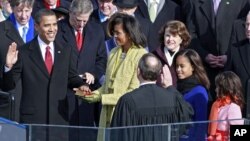 Barack Obama is sworn in by Chief Justice John Roberts as the 44th president of the United States