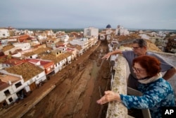 Two people look out over an area affected by floods in Chiva, Spain, on Nov. 1, 2024.