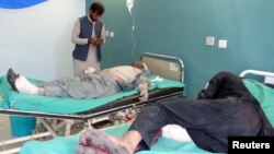 Afghan men receive treatment at a hospital after a suicide car bomber and gunmen attacked a provincial Afghan police headquarters in Gardez, the capital of Paktia province, Afghanistan, Oct. 17, 2017. 