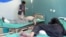 Afghan men receive treatment at a hospital after a suicide car bomber and gunmen attacked a provincial Afghan police headquarters in Gardez, the capital of Paktia province, Afghanistan, Oct. 17, 2017. 