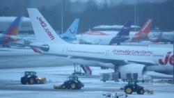 Sejumlah staf bandara membersihkan landasan pacu di Bandara Manchester, Inggris, dengan menggunakan traktor pada 5 Januari 2025. (Foto: Reuters/Phil Noble)