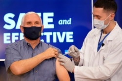 Vice President Mike Pence receives a Pfizer-BioNTech COVID-19 vaccine shot at the Eisenhower Executive Office Building on the White House complex, Dec. 18, 2020, in Washington.
