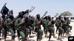 FILE - Hundreds of al-Shabab fighters perform military exercises in the Lafofe area, south of Mogadishu, in Somalia, Feb. 17, 2011. 