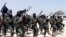 FILE - Hundreds of al-Shabab fighters perform military exercises in the Lafofe area, south of Mogadishu, in Somalia, Feb. 17, 2011. 