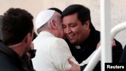 Fabian Baez, a priest from a church in downtown Buenos Aires, is greeted by Pope Francis at the end of the Wednesday general audience in Saint Peter's square at the Vatican, Jan. 8, 2014.