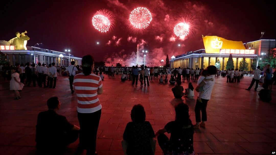 North Koreans gathered at Kim Il Sung Square to watch as fireworks explode in central Pyongyang, North Korea, July 27, 2014. 
