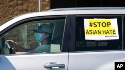 FILE - Members of the Korean American Federation of Los Angeles drive with signs reading "#Stop Asian Hate," in a caravan around Koreatown, March 19, 2021. (AP Photo/Damian Dovarganes, File)
