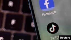 FILE - This illustration shows Facebook and TikTok apps.