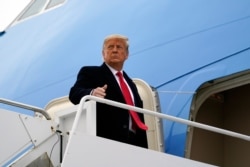 FILE - President Donald Trump gestures as he boards Air Force One upon arrival at Valley International Airport, in Harlingen, Texas, Jan. 12, 2021.