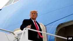 FILE - President Donald Trump gestures as he boards Air Force One upon arrival at Valley International Airport, in Harlingen, Texas, Jan. 12, 2021.