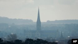 The combined tower and spire of Salisbury Cathedral stand surrounded by the medieval city where former Russian double agent Sergei Skripal and his daughter were found critically ill following exposure to the Russian-developed nerve agent Novichok in Salisbury, England, Tuesday, March 13, 2018. 