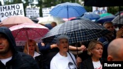 A woman in a T-shirt with the portrait of Dzenan Memic takes part in a protest in Sarajevo, Bosnia and Herzegovina, May 15, 2018.