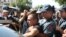 Armenian police detain an unidentified man in Yerevan, Armenia, June 17, 2016. Armed supporters of a jailed opposition leader attacked a police station in Armenia's capital on Sunday.