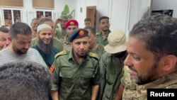 FILE - Members of the 444th Brigade receive commander Mahmoud Hamza, who was detained as he attempted to travel from Mitiga airport, causing clashes between armed factions, in Tripoli, Libya, August 17, 2023. 444th Brigade/Handout via REUTERS