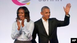 FILE - Former President Barack Obama, right, and former first lady Michelle Obama appear at the Obama Foundation Summit in Chicago, Oct. 31, 2017. 