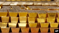 FILE - Gold bars are stacked in a vault at the United States Mint in West Point, New York, July 22, 2014. Some African nations' central banks are buying gold to bolster and protect their economies, experts say.