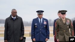 FILE - Defense Secretary Lloyd Austin, Chairman of the Joint Chiefs of Staff Gen. CQ Brown and Marine Corp. Sgt. Maj. Troy E. Black watch as an Army carry team moves the transfer case containing the remains of three US soldiers at Dover Air Force Base, Del., February 2, 2024.