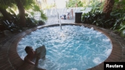 FILE - A woman reads in the hot tub in New Orleans, Louisiana, Nov. 28, 2014. 