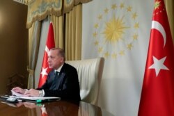 Turkish President Recep Tayyip Erdogan participates in a teleconference with European leaders, in Istanbul, Tuesday, March 17, 2020.