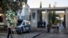 People carry wreaths at Mingorrubio's cemetery, on the outskirts of Madrid, Spain, Oct. 24, 2019. Forty-four years after his death, the remains of Spanish dictator Gen. Francisco were exhumed from his resting place and taken to a small family crypt.